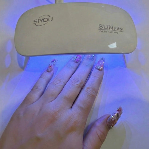 SIYOU portable mini nail lamp showing LED lights - lifestyle shot