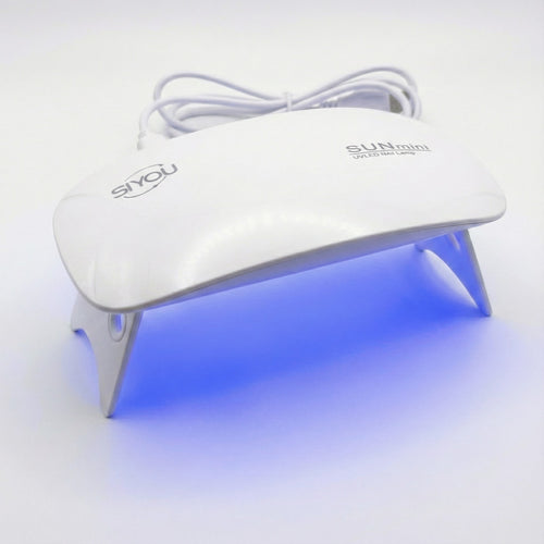 SIYOU portable mini nail lamp showing LED lights - lifestyle shot